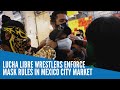 Lucha libre wrestlers enforce mask rules in Mexico City market