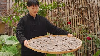 Boy making Chinese dumplings with taro