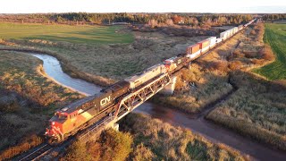 Awesome Aerial 4K View! Big Fast Stack Train CN 120 w/DPU passing Nappan, NS during Golden Hour