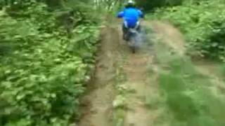 hayden riding his ktm in our woods after the rain