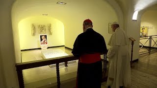Pope Francis visits papal grotto in St. Peter's Basilica, with tombs of past popes