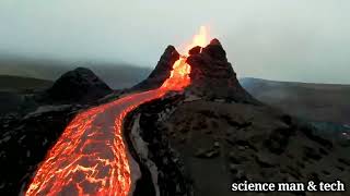 Spectacular drone footage flying over lava fields and an erupting volcano in Iceland