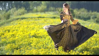 Awesome cute girl dancing happily in a field of flowers