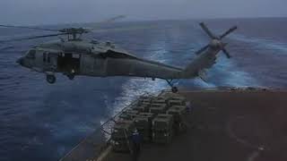 Helicopter aircrewman falling out of MH-60S helo