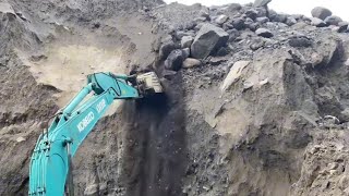 Excavators work in sand mining cutting cliffs, heavy equipment operators are reckless