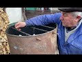 elderly couple has a happy old age cooking meat on smoke based on an ancient recipe