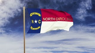 4K north carolina flag with title waving in the wind. Looping sun rises style. Animation loop Stock