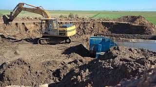 Excavator Caterpillar 315 loading a truck