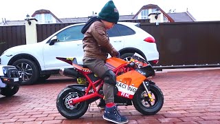 Senya testing a children's motorcycle