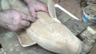 We cut scales on carp, wooden goblets in the form of carp