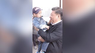 President Xi hugs a boy during his inspection in Shanghai