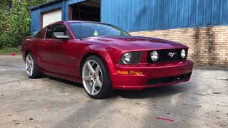 2005 Ford Mustang Sitting on 20” str  Brushed aluminum 607 wheels wrapped in 245/35-20 Lexani tires