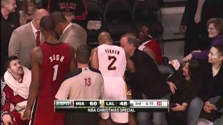 Ron Artest dives into the Miami Heat bench