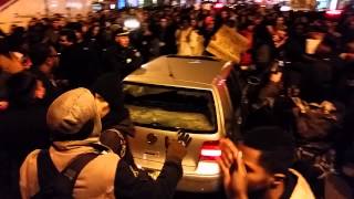 Protesters punch out car window