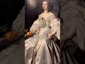 her satin dress is exquisite and very fashionable around 1650. look at the sharp folds. costume