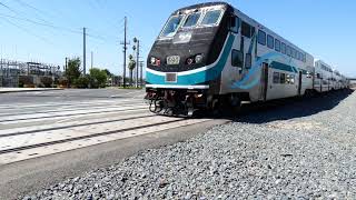 (4K) Metrolink rushes by railroad crossing