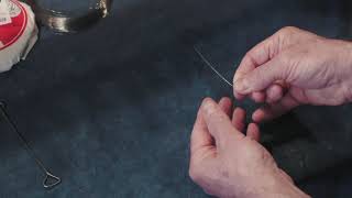 How to replace a sympathetic string or taraf on a sitar
