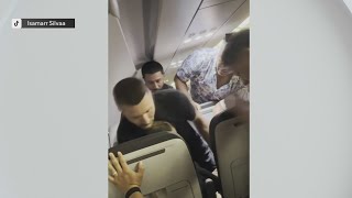 Video shows passengers detaining man accused of trying to open plane door on flight diverted to MIA
