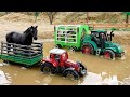 Toy tractors carry animals across puddles to the farm