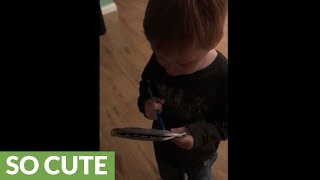 Precious toddler helps mom with the grocery list