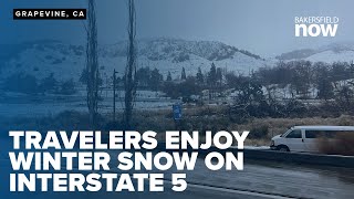 Grapevine snow delight: Travelers stop on Interstate 5 to enjoy winter storm