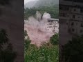 Building partially collapses amid rushing floodwaters in China