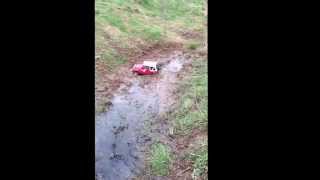 Radio Controlled Suzuki SJ playing in a muddy ditch,