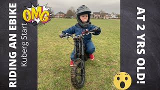 2 year old riding a Kuberg Start kids e bike