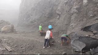 Fog Descends as Miners Enthusiastically Load Sand Into Trucks.