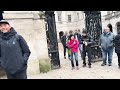 zero tolerance for rule breakers guard confronts tourists outside the white line.