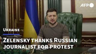 Zelensky thanks protester who interrupted Russian TV news with anti-war poster | AFP