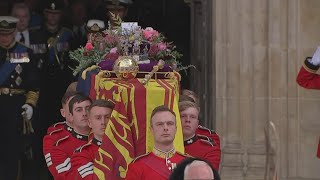 King Charles III leaves Westminster Abbey behind Queen Elizabeth II's coffin