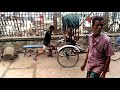 slow mo rickshaw puller pumping wheels by hand