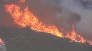 Brush fire burning in hills west of Los Angeles