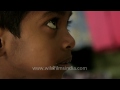 mother feeds rice to her son before going to school assam