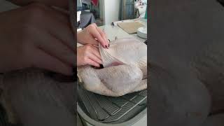 Stuffing the herb butter under the skin.