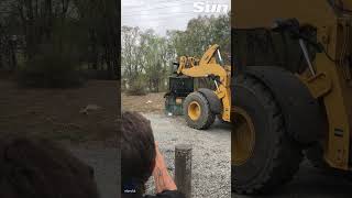 Bear trapped in dumpster is set free by bulldozer