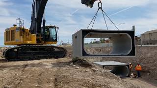 John Deere 670G Excavator Laying Concrete Bricks