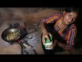 village girl cooks chicken gravy with traditional spices on firewood stove