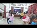 kids practicing dance, by watching TV