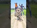 two statues in front of a tractor