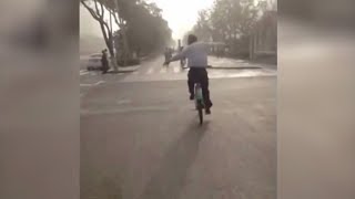 A true multitasker: Chinese man practices Tai Chi while riding bike