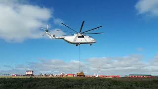 The MI26 helicopter easily carries a 30-ton bulldozer into a swampy area