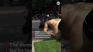 Teachers union protesters tear down World Cup statues in Mexico