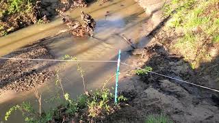 Swollen creek from rain storm, will the cattle mob be able to cross it?