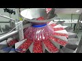 PrimoCombi multihead weigher dispensing pomegranate seeds into containers