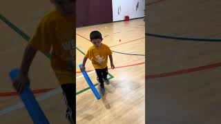 Kayden Playing Floor Hockey at the YMCA