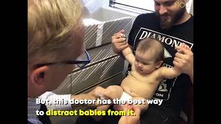 Doctor distract the baby for vaccine shot.