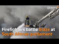 Firefighters battle blaze at South African parliament