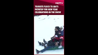 Tourists Throng City For New Year Celebration Amid Snowfall